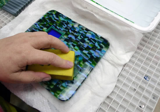 Coldworking fused glass with diamond hand pads.